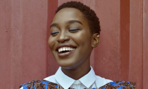 Portrait of a young woman in a blue floral dress smiling