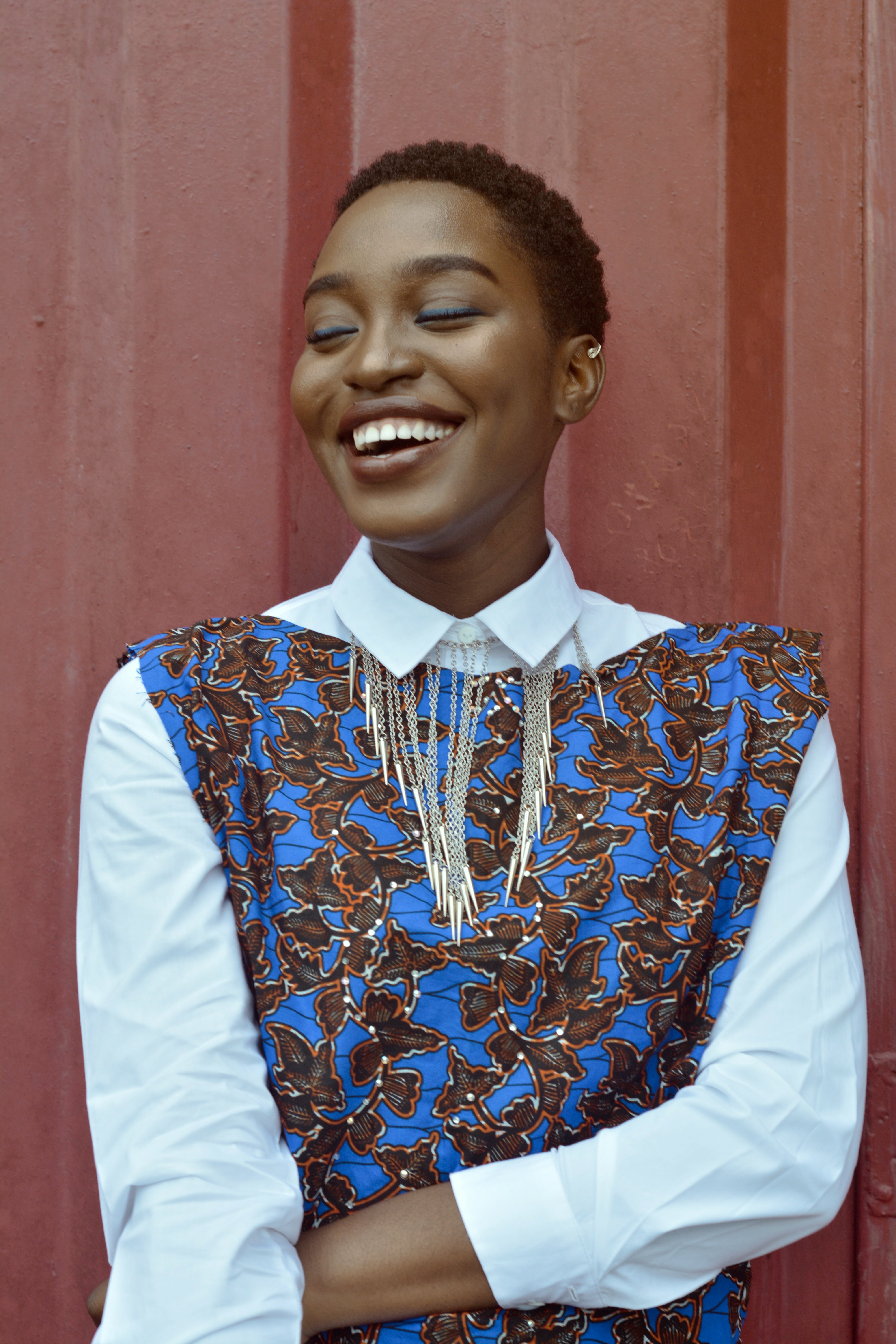 Portrait of a young woman in a blue floral dress smiling